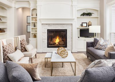 living room with grey couches facing fireplace